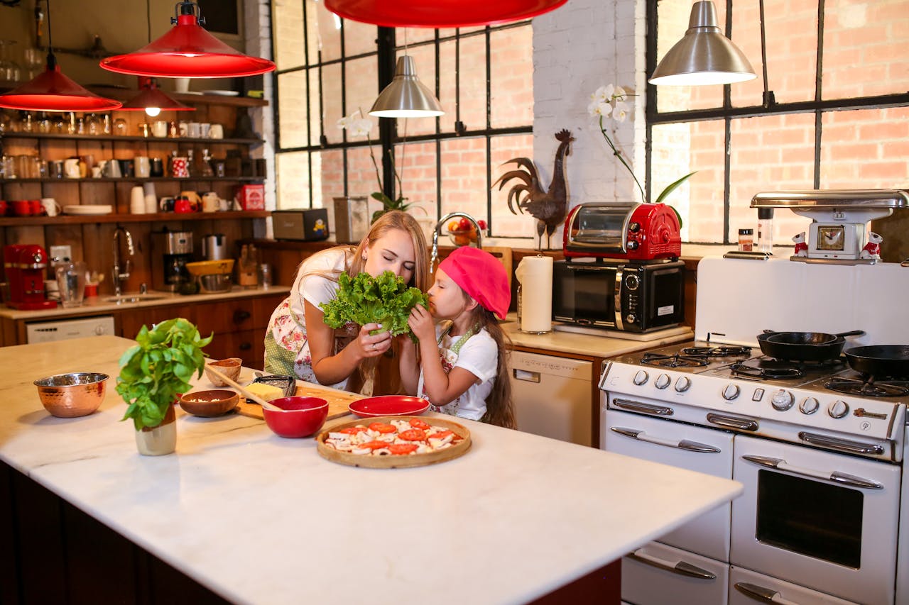 A mother and daughter enjoying a cooking session together in a homey kitchen setting.